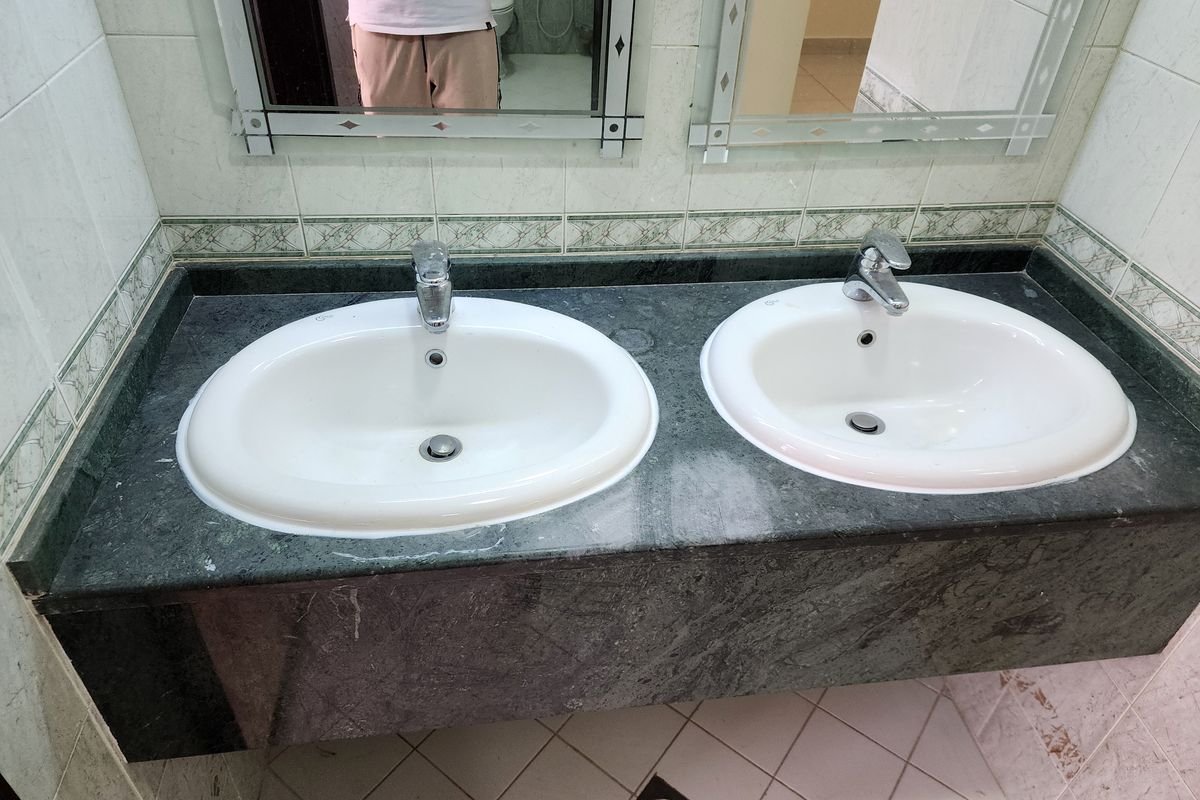 Twin basins and marble top stained before restoration