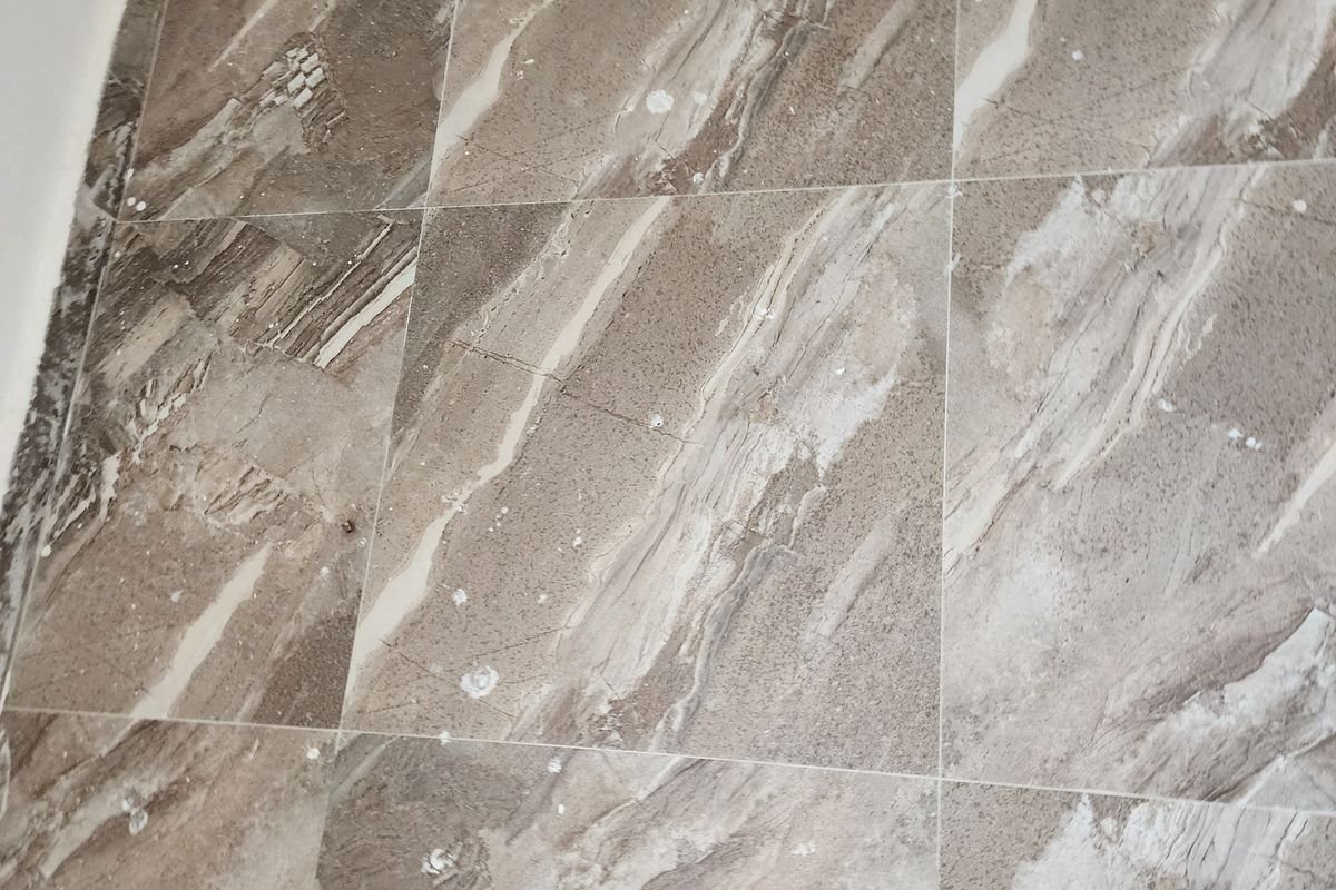 Marble floor dulled by dust and residue before machine scrubbing
