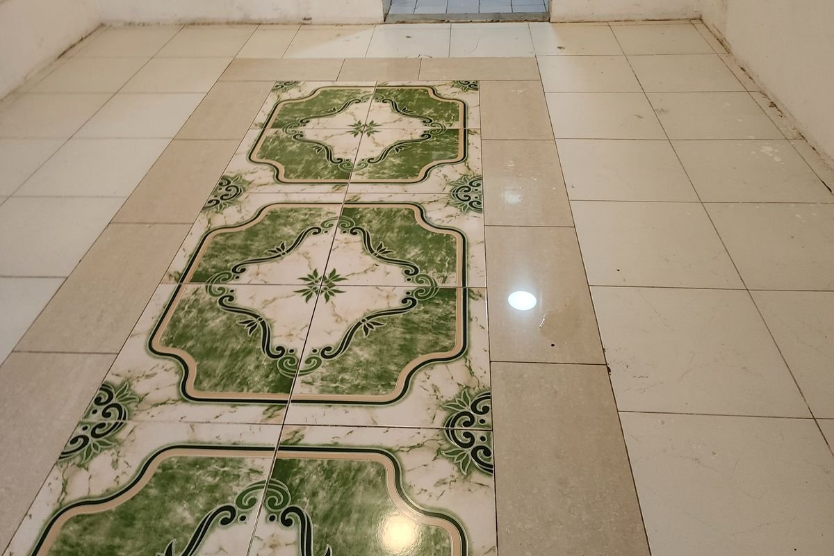 Patterned tiled floor bright and clean after machine scrubbing