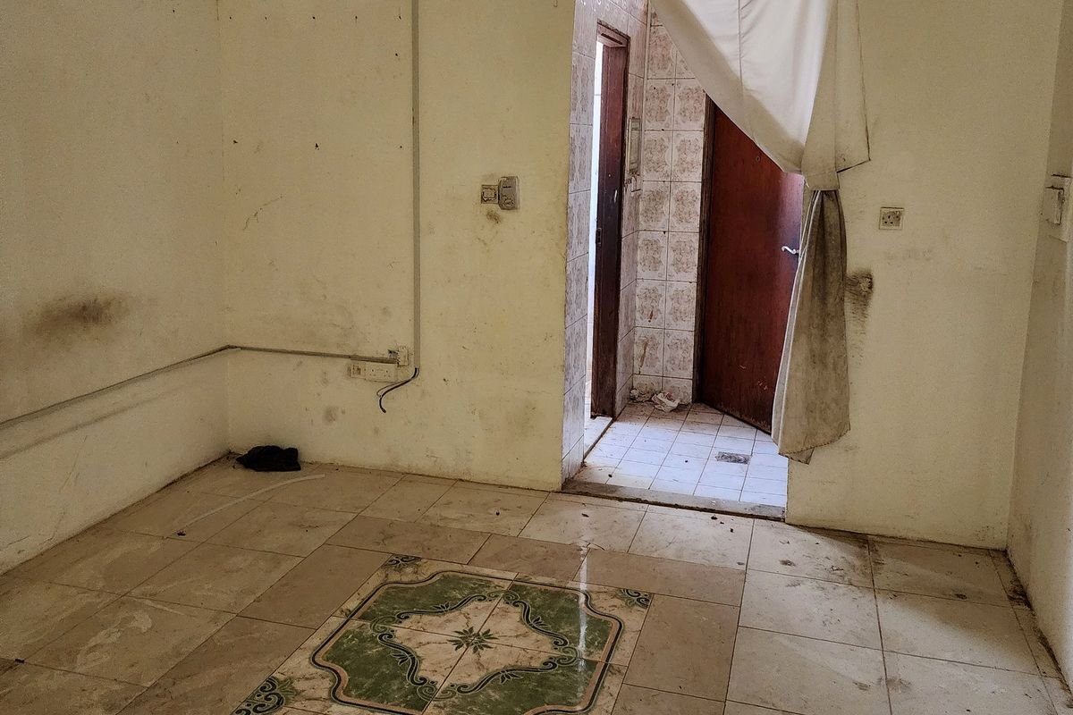 Neglected tiled floor with ingrained soil before floor scrubbing