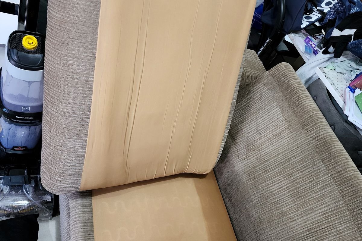 Fabric sofa with soiled cushions before injection extraction cleaning